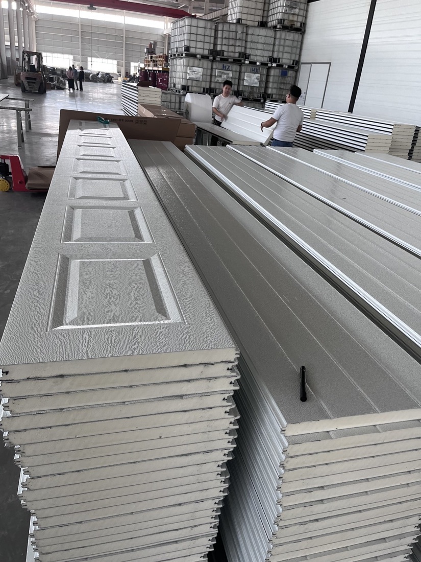 Raised panel garage door sections stacked in workshop